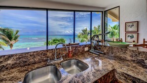 A kitchen with a large window overlooking a beach and ocean. - Half Moon Harbor Villa - Stunning ocean views and privacy at this poolside oasis (Akumal)