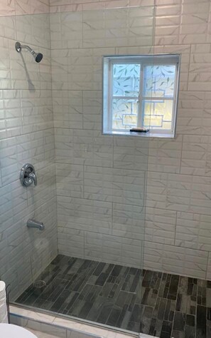 Shower, hair dryer, towels, toilet paper