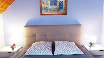 A bedroom with a large bed, two nightstands, a painting on the wall, and a wooden sloped ceiling.