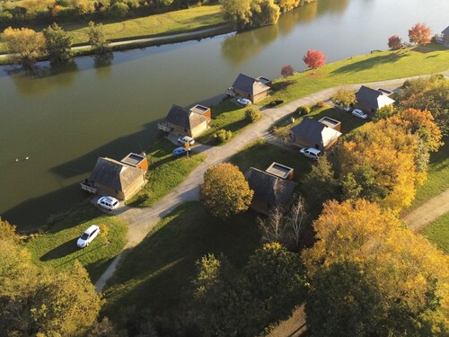 "Charming Lakeside Chalet with Private Fishing Pier, Game Room, and Nearby Village Amenities"