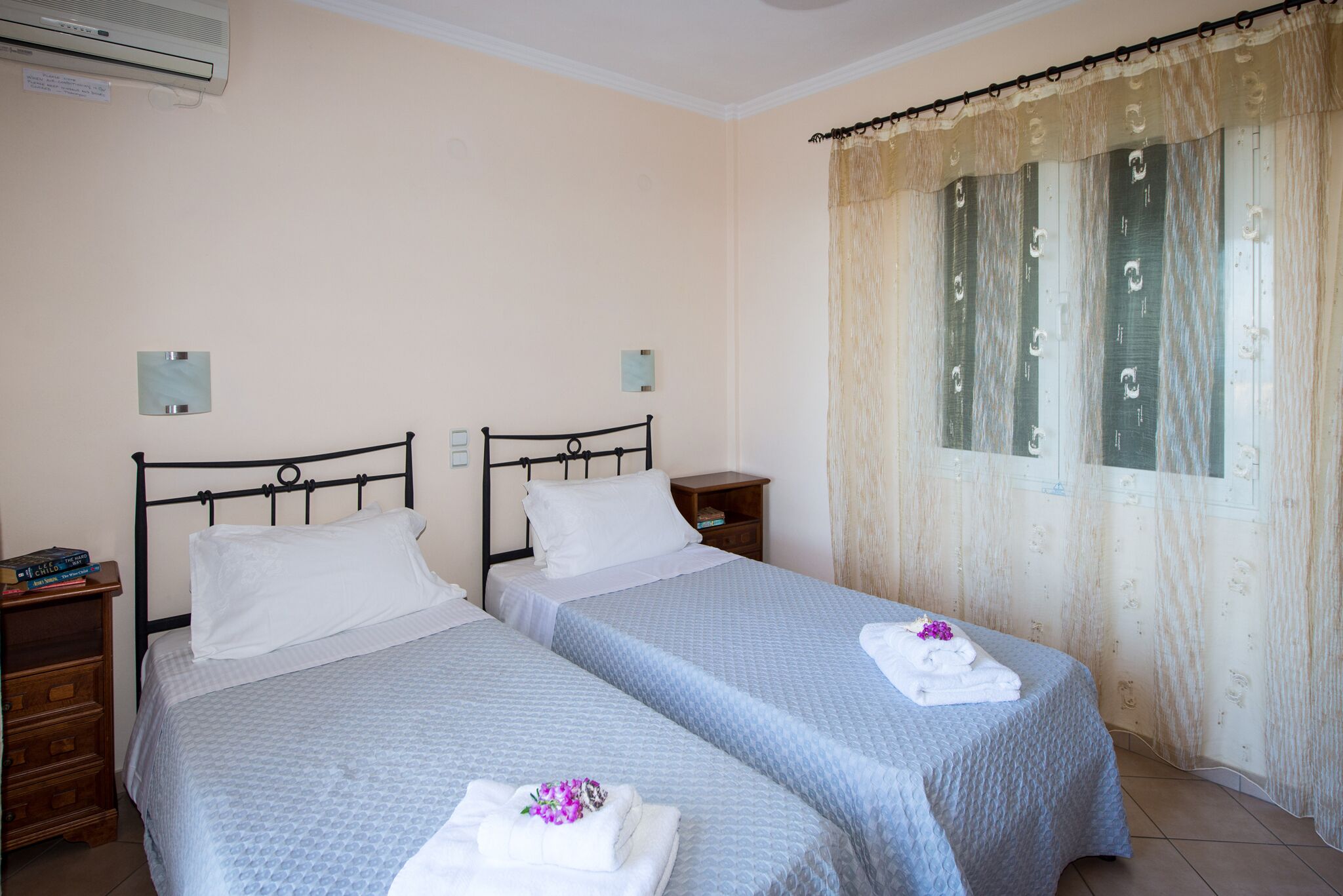 Una habitación con dos camas, cada una con una almohada y una mesita de noche.