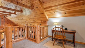 A wooden staircase with a railing, a desk with a chair, and a lamp. - Serenity Hill 42 Midland Drive: 3  BR, 3  BA Cabin / Bungalow in Waynesville, Sleeps 6 (Waynesville)
