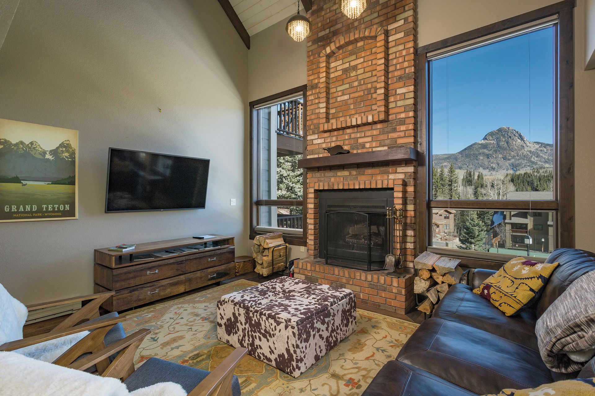 A living room with a fireplace, a television, and a sofa.