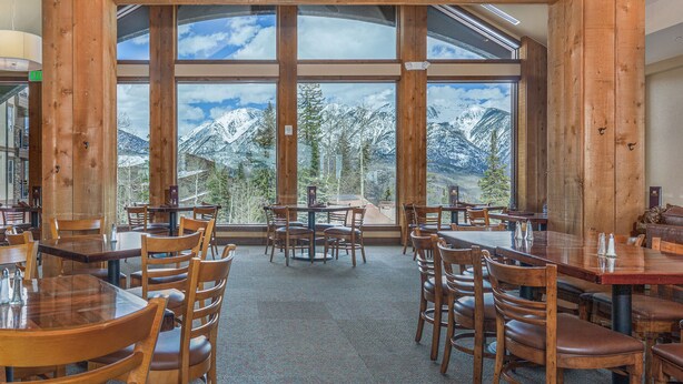 A restaurant with large windows offering mountain views, wooden interior, and multiple seating arrangements. - Penthouse in Purgatory Lodge - Views - Ski in/Out - Pool Table (Durango)