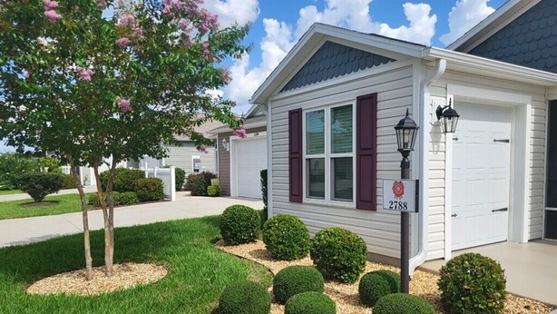 A single-story house with a white exterior, dark shutters, and a mailbox with the number 2788.