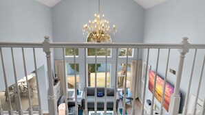 A high-ceiling room with a chandelier, a large window, and a view of the outdoors. - 2 Golf Carts ~ Golf Course Views ~ Lake Views (Miramar Beach)