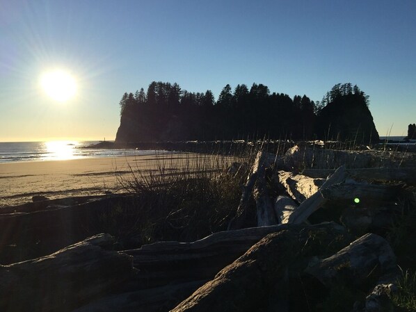 A beach with a rocky foreground, a clear sky, and the sun low on the horizon. - The Hideaway - Escape to Serenity (Forks)