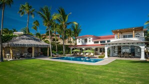 A resort with a swimming pool, outdoor seating, and palm trees. - 4 BR Cas Lita Includes A/C, WiFi, Private Pool and Much More! (Palmilla)