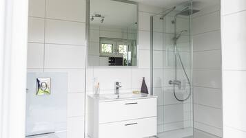 Shower, hair dryer, slippers, towels
