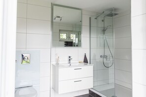 Een douche, een haardroger, pantoffels, handdoeken