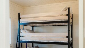 A bunk bed with a ceiling fan and a window. - Haven on Ida - Lakeside Cabin, Cozy Porch + Sauna + Kayaks (Alexandria)