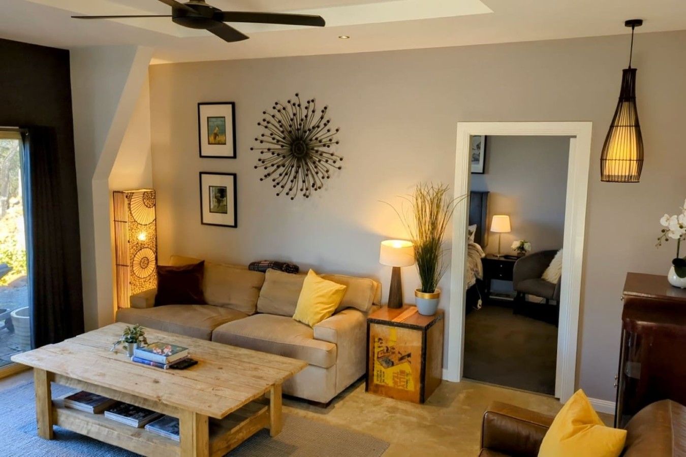 A modern living room with a sofa, coffee table, and decorative lamps.