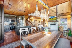 A spacious kitchen with a large island, wooden ceiling, and hanging light fixtures. - All Decked Out - Blue Ridge Heights (Blue Ridge)