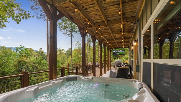 A hot tub on a wooden deck with a view of trees and mountains. - Serenity Now - Cherry Log (Cherry Log)