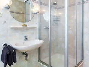 Shower, hair dryer, soap, toilet paper