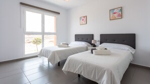A hotel room with two beds, a large window, and artwork on the walls. - BUTTERFLIES POOL 4 TRANQUILITY AND RELAXATION (Puerto del Rosario)
