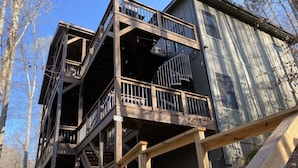 A multi-story wooden structure with balconies and a spiral staircase.