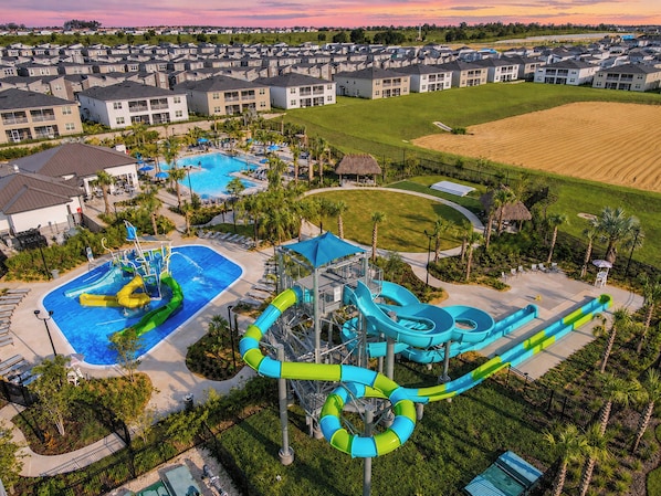 A residential area with a water park featuring pools and slides.