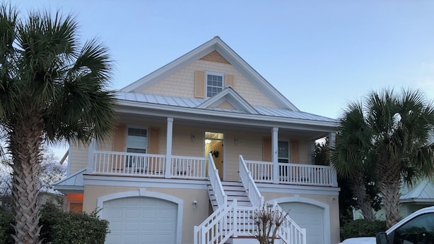 A two-story house with a front porch, a garage, and a staircase leading to the second floor. - 2 BR, 1 bath w full kitchen on ground level w full kitchen w access to amenities (Murrells Inlet)