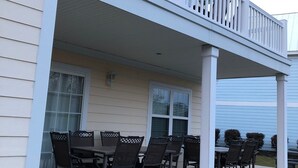 A covered patio with outdoor furniture and a railing. - 2 BR, 1 bath w full kitchen on ground level w full kitchen w access to amenities (Murrells Inlet)