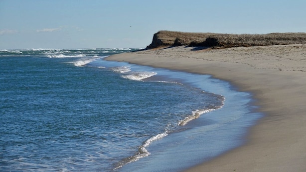 A beach with a sandy shore and a cliff. - BEST OF ALL WORLDS! Beach, Lake, Town, Bike, and Comfort. (Chatham)