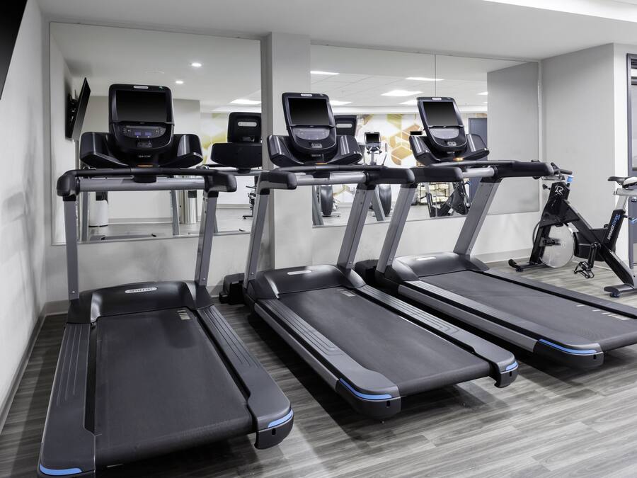 A gym with multiple treadmills and exercise bikes.