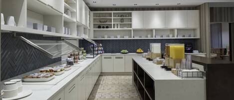 A modern kitchen with white cabinetry, a herringbone-patterned backsplash, and a geometric tile floor.