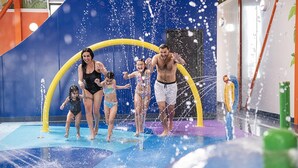 A water play area with a yellow arch structure and a blue floor.