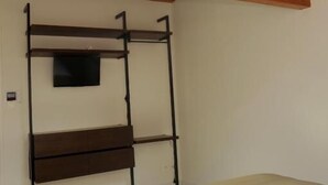 Een kamer met een stapelbed, een dakraam en een bed met een witte matras.