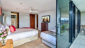 Une chambre moderne avec un grand lit, une table de chevet ornée d’un vase de fleurs, une commode et un téléviseur. Une porte-fenêtre coulissante donne accès à un balcon où se trouve une chaise.