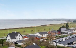 Stunning homes line the scenic road, offering a serene lakeside setting.