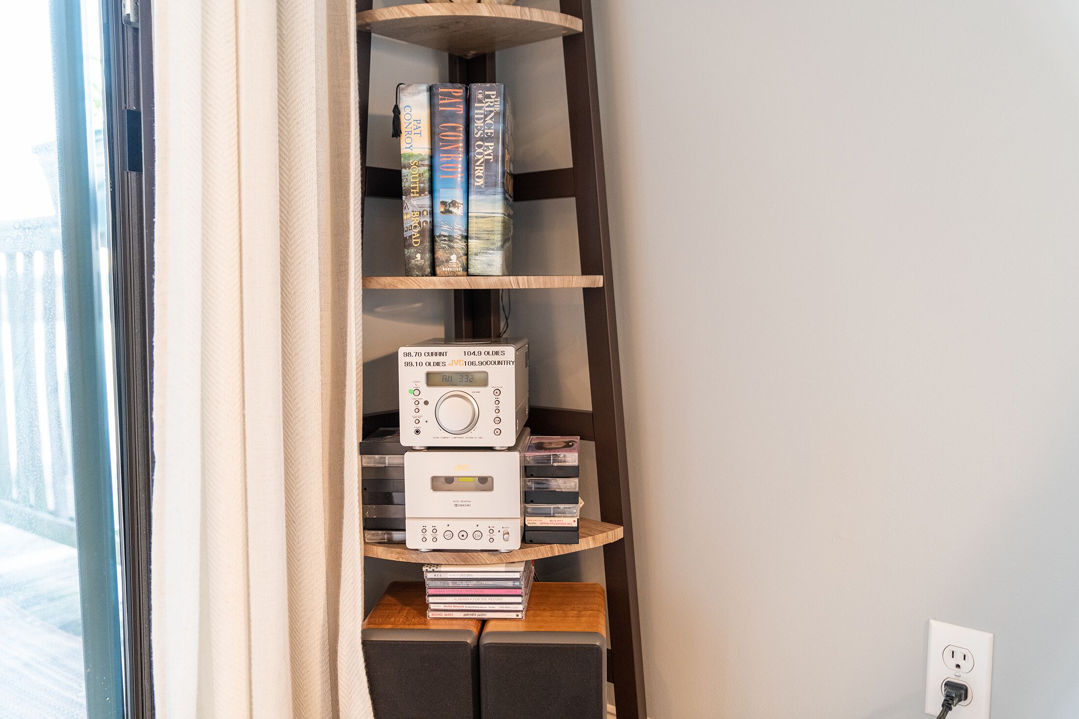 A bookshelf with books and audio equipment.