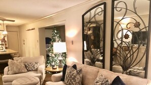 A living room with a beige sofa, two armchairs, and a coffee table. A Christmas tree is visible in the background. - Highest Elevation in Snowshoe. Home+Interior building renovated 2023.
 (Snowshoe)
