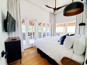 A bedroom with a bed, a TV, and a ceiling fan. - Heated Pool- Steps from Seaside- View of the Gulf of Mexico (Santa Rosa Beach)