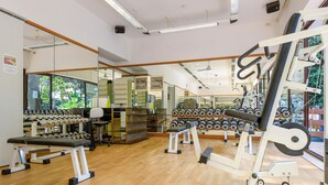A gym with various exercise equipment, including dumbbells and weight machines, and a mirror wall. - Stunning home in Lido di Spina FE with swimming pool (Lido di Spina FE)