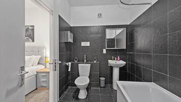 Apartment, 2 Bedrooms | Bathroom | Combined shower/bathtub, free toiletries, hair dryer, soap