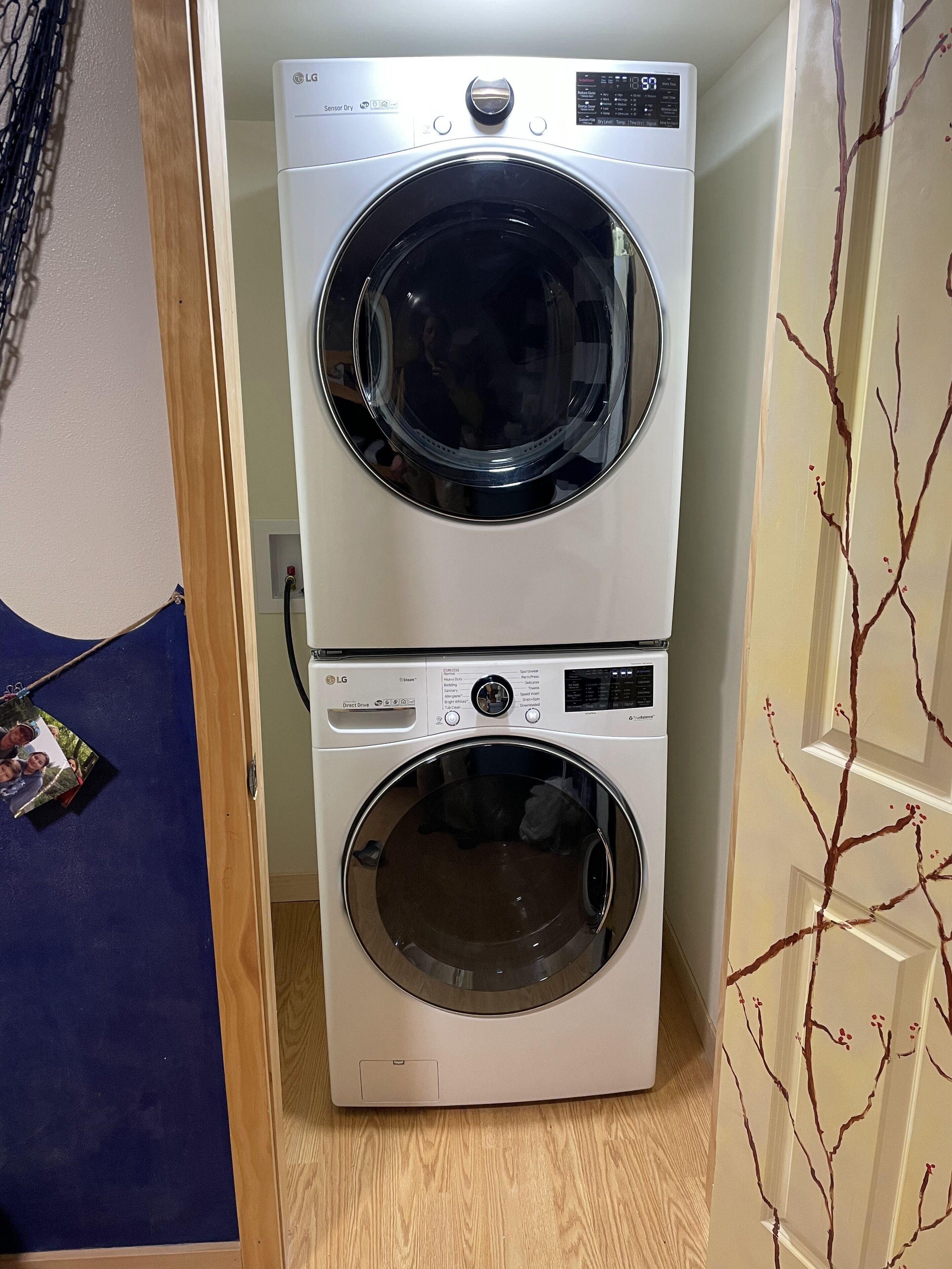 A laundry room with two stacked front-loading washing machines.