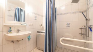 Shower, hair dryer, soap, toilet paper