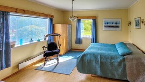 A bedroom with a bed, a chair, a window, and a door. - Gorgeous home in Reksteren with kitchen (Reksteren)