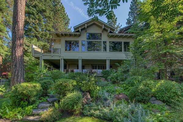 A two-story house with a balcony, surrounded by dense greenery and trees. - Making Memories - Incline Village Lakeview - TLUXP (Incline Village)