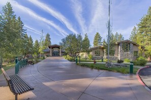 A building entrance with a covered walkway, surrounded by trees and a bench. - Making Memories - Incline Village Lakeview - TLUXP (Incline Village)