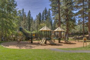 A playground with slides and climbing structures surrounded by trees. - Making Memories - Incline Village Lakeview - TLUXP (Incline Village)