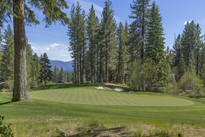 A golf course with a well-maintained fairway, sand bunkers, and tall pine trees. - Making Memories - Incline Village Lakeview - TLUXP (Incline Village)