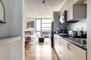 Fridge, microwave, stovetop, coffee/tea maker - Smart Lincoln Park Studio w/ W/D, walk to L & New City, by Blueground (Chicago)