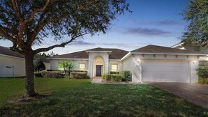 A residential house with a driveway, a garage, and a well-maintained lawn. - 418 - Fabulous 4 Bed Home with South Facing Pool and Spa (Davenport)