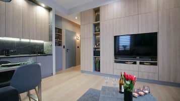 Comfort Apartment, Non Smoking, City View | Living area | 55-inch LED TV with satellite channels, TV, smart speakers