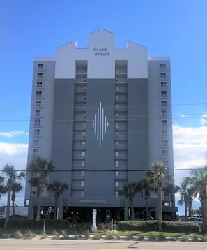 Island Royale offers a modern, symmetrical facade with a central palm tree motif.