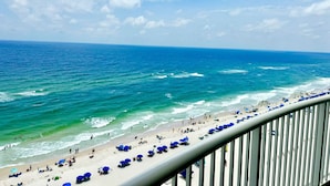 A beach with people, umbrellas, and a railing. - Premiere Complex. Beachfront Penthouse Unit W/ Amazing View, Extra Large Balcony (Gulf Shores)