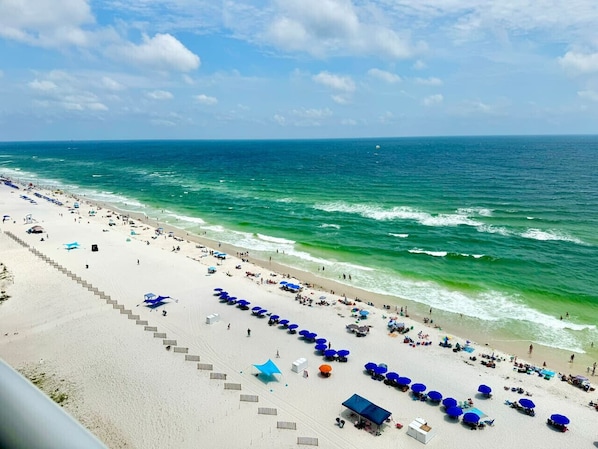 Guests can stroll along the promenade to the beach, lined with umbrellas for shade.
