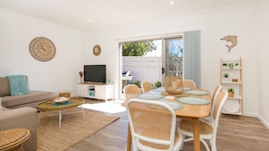 Relax in this cozy living space with a dining area, TV, and comfortable seating.